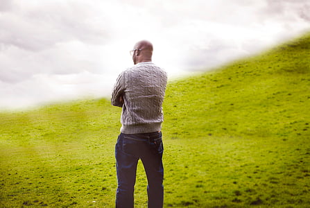 man standing on hill covered with fogs at daytime thumbnail