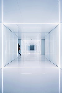 person walking inside white hallway thumbnail