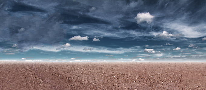 landscape photography of brown soils under cirrus clouds thumbnail