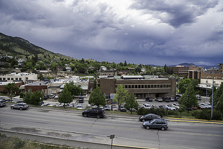 Cars and buildings under cloudy sky in Helena, Montana thumbnail