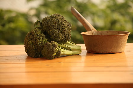 selective focus photography of broccoli on brown wooden surface thumbnail