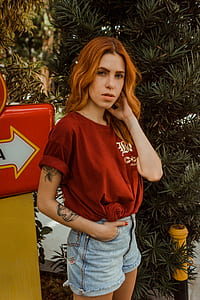 woman standing beside box and trees thumbnail