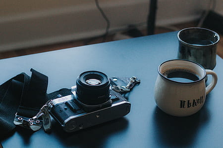 black and gray film camera laid on gray table thumbnail