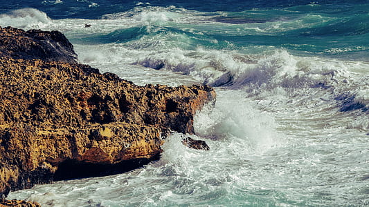 brown rock with body of water thumbnail