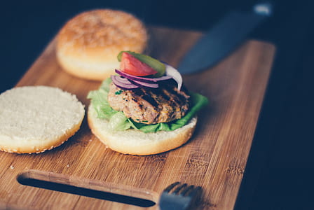 Shallow Focus Photography of Burger Sandwich Served on Brown Wooden Chopping Board thumbnail