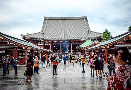 people standing near gray temple thumbnail