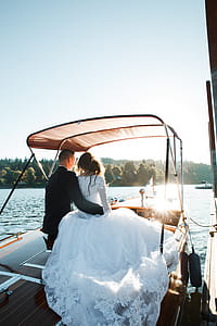 Wedded Couple Sitting on Motorboat thumbnail