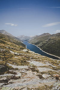 calm body of water in between of green mountain thumbnail