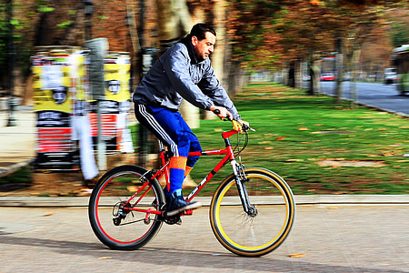 panning photography of man biking thumbnail