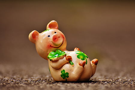 shallow focus photography of brown ceramic pig figurine thumbnail