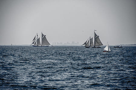 five white sail boats on ocean at daytime thumbnail