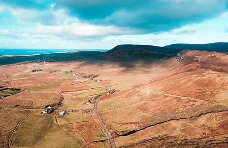 aerial photograph of a mountain under blue skies thumbnail