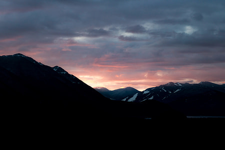 silhouette photo of mountains during sunset thumbnail
