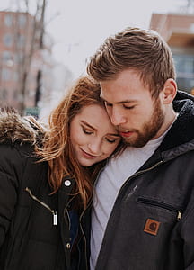 selective focus photo of man and woman wearing black zip-up tops thumbnail