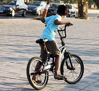 boy riding black BMX bike thumbnail