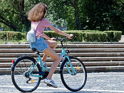 Woman Riding Bicycle Near Concrete Stairs thumbnail