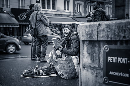 Person Sitting Behind Wall Grayscale Photo thumbnail