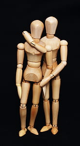 two brown wood dolls thumbnail