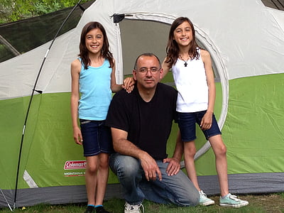 man between two girls near tent thumbnail