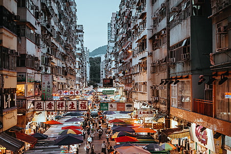 food stalls beside white high-rise buildings during daytime thumbnail