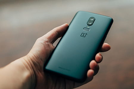 person holding black OnePlus 6 Android smartphone thumbnail