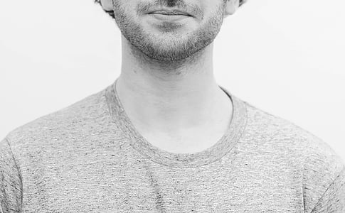 grayscale photo of bearded man wearing crew-neck top thumbnail