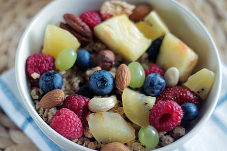 fruits and nuts filled white ceramic bowl thumbnail