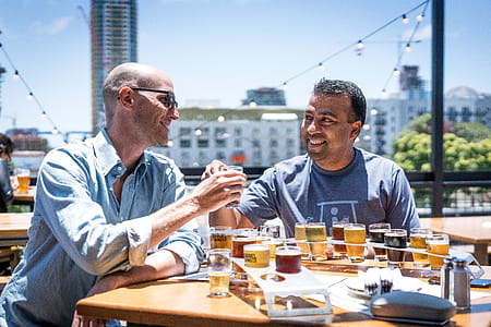 Two Men Drinking Outside Restaurant thumbnail
