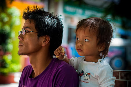 man wears pink crew-neck shirt near toddler wears white crew-neck long-sleeved shirt thumbnail