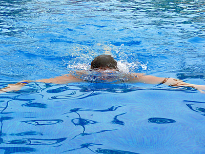 man swimming on body of water thumbnail