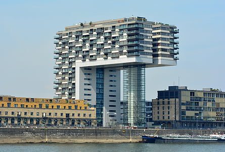 architectural photography of white building near body of water thumbnail