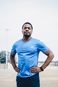 tilt-shift photography of man in blue Nike crew-neck shirt thumbnail