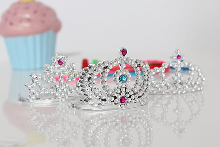 three silver-colored crowns thumbnail