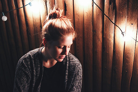 Girl looking down surrounded by lights thumbnail