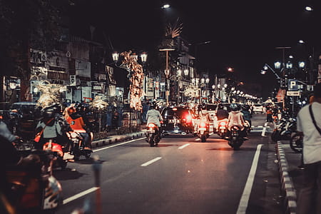 People Riding Motorcycles On Road During Night Time thumbnail