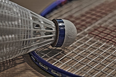 white shuttlecock on badminton racket thumbnail