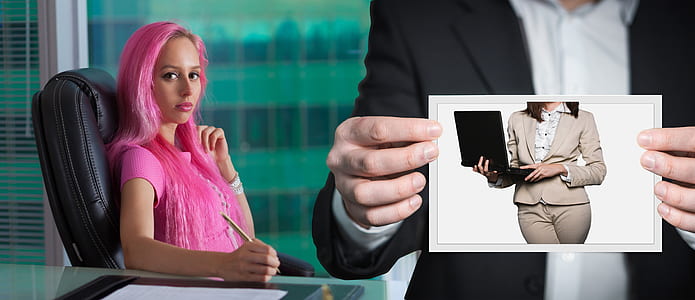 woman with pink hair sitting on black leather rolling chair thumbnail