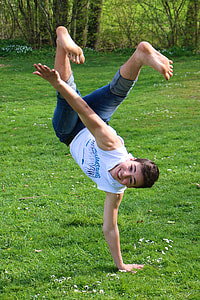 man dancing on grass during daytime thumbnail