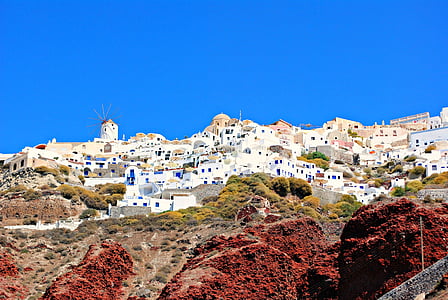 white painted houses under clear blue sky thumbnail