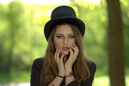 woman with black hat during daytime thumbnail