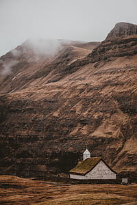 white concrete house below mountain during daytime thumbnail