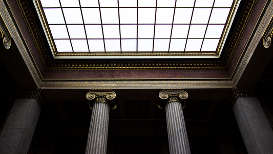 low angled vie of brown and brass columns ceiling structures thumbnail