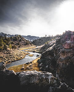 river between hill at daytime thumbnail