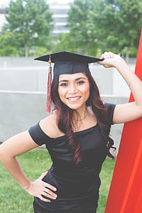 woman holding mortar board outdoors thumbnail