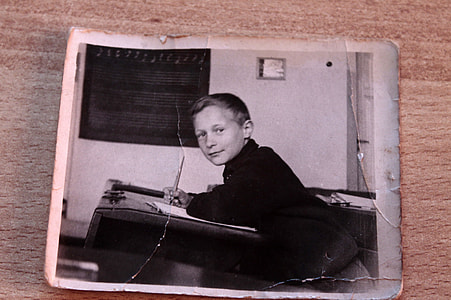 boy writing on desk grayscale photo thumbnail