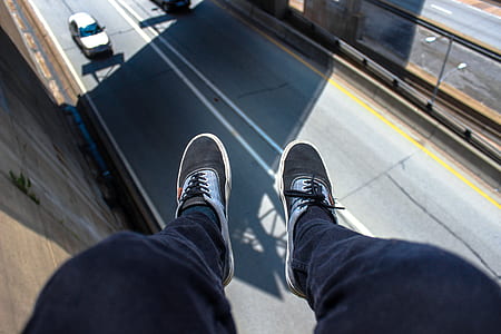 Man in Blue Pants Wearing Black and White Lace Up Low Top Sneakers thumbnail