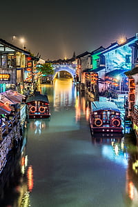 several boats near wooden structures thumbnail