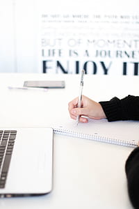 person writing on white lined paper thumbnail