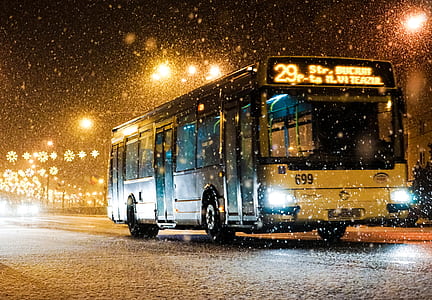 white and black bus driving on road during nighttime thumbnail