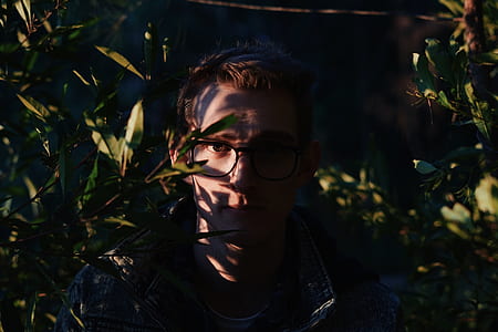 man standing near green plants thumbnail